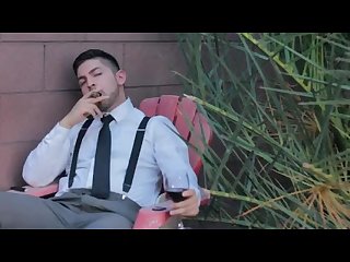 Handsome classy man smoking cigar in his suspenders suit tie clean cut male