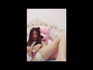 Pretty Chinese camgirl plays with her fat pink pussy
