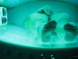 Peep hole spy cam on wife masturbating in tanning bed orgasms