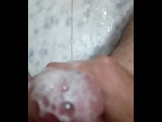 Brown stud stroking his soapy cock