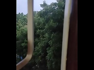 Husband fucking wife in doggy style by enjoying the rain from window