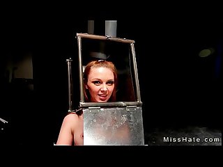 BDSM babe with head in steel box spaked
