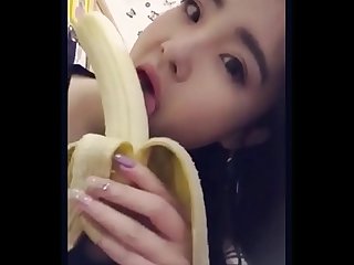 Asian teen playing with pussy and sucking dildo