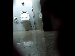 Curly blonde latina spied in toilet by hidden cam
