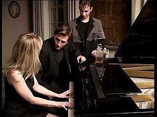 Blonde whore playing piano and two cocks