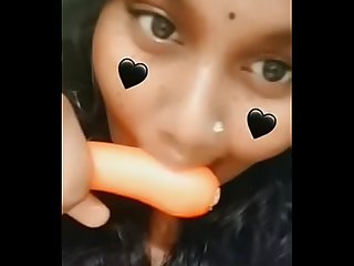some indian girl sucking a carrot